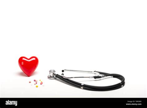 Front View Of Plastic Red Heart Stethoscopes And Drugs On White