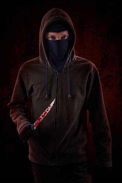 Hooded Man In Mask With A Knife Stock Photos Pictures And Royalty Free