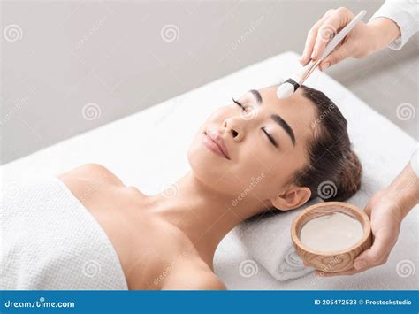 Beauty Treatment Beautician Applying Clay Mask To Asian Woman At Spa Salon Stock Image Image