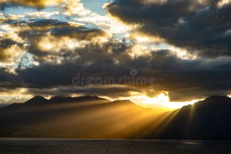 Dramatic Sunset With Beautiful Rays Over The Mountains And The Sea