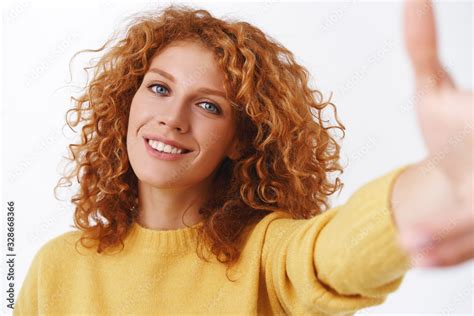 Close Up Attractive Happy Smiling Redhead Woman With Curly Hair Pulling Hand Forward As Holding