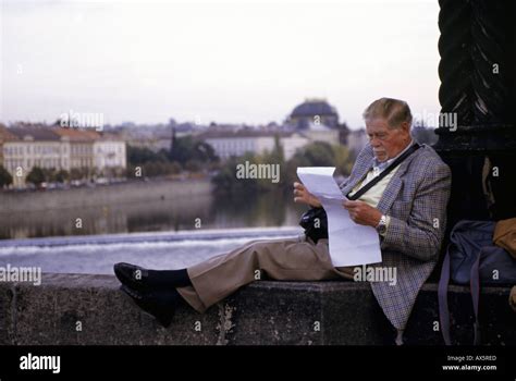 Prague Czech Republic Man In A Sports Jacket Reading A Piece Of Paper