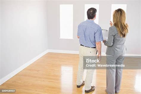 Blonde Real Estate Agent Showing A Room To A Potential Buyer Stock