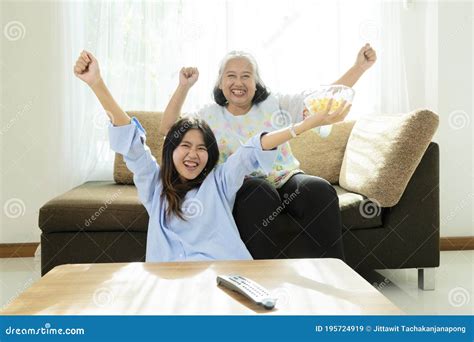 Asian Niece And Grandma Enjoying Watching Movies And Eating Popcorn Stock Image Image Of