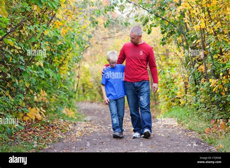 Father And Son Walking On A Path In A Park In Autumn Edmonton Alberta
