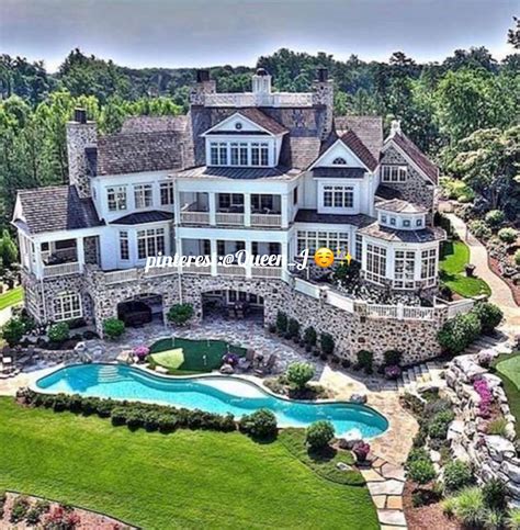 An Aerial View Of A Large House With A Pool In The Front Yard And