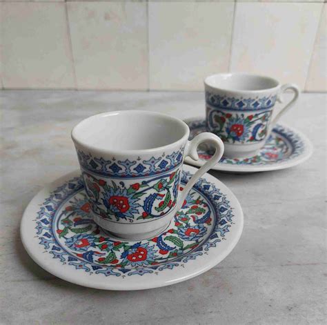 A Pair Of Kutahya Porselen Espresso Demitasse Cups And Saucers