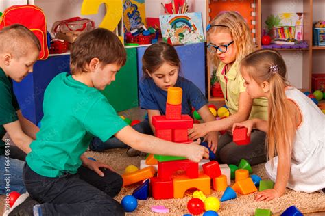 Children Building Blocks In Kindergarten Group Kids Playing Toy On