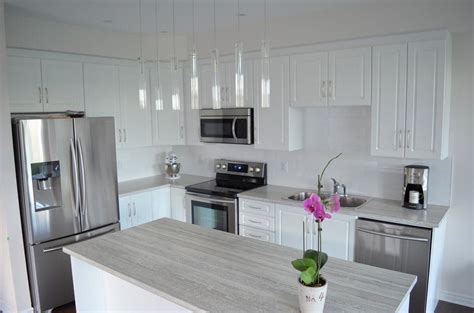 Modern open concept kitchen with island. Open concept kitchen with island. Light colour laminate ...