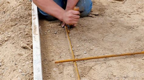 Worker Using Tie Wire To Secure Reinforcement Rebar Rods In Place Stock Footage Video Of