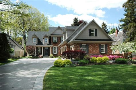 Red brick house with black shutters and pretty manicured lawn / garden. 81 Gorgeous Red Brick Houses (Photo Ideas) - Home Stratosphere