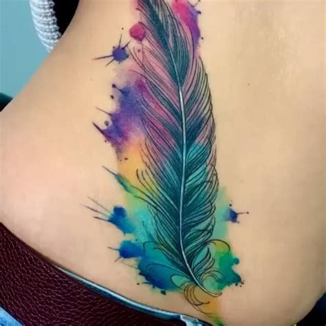 Rainbow Feather Tattoo On The Back Feather Tattoos Feather Tattoos