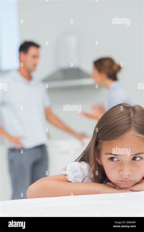 Upset Little Girl Listening To Parents Who Are Arguing Stock Photo Alamy