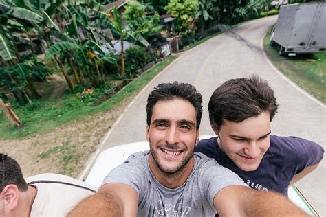 Happy Friends Taking Selfie Traveling On Top Of A Bus On Adventure Travel By Stocksy