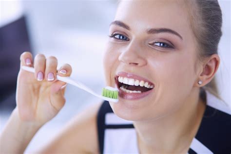 Premium Photo Young Pretty Girl Maintaining Oral Hygiene With Toothbrush