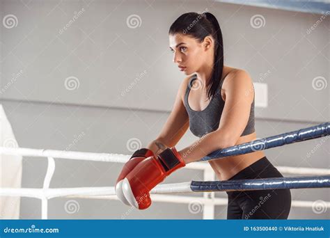 Boxing Woman In Gloves Boxer Leaning On Rope On Ring Looking Aside