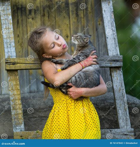 Little Girl Holding A Cat In Her Arms Stock Photo Image Of Love