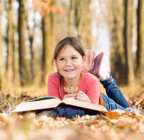 Little Girl Is Reading A Book Outdoors Stock Photo By ©kobyakov 35839517