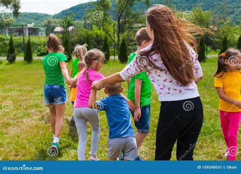 Utor With Kids Play In Outdoor Games And Have Fun Stock Image Image