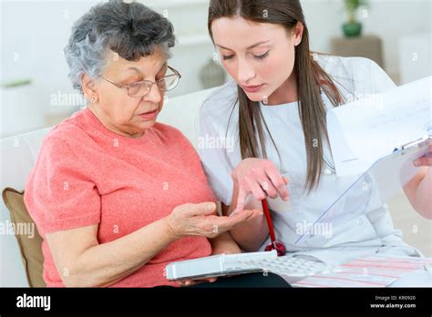 Doctor Helping Patient With Medication Stock Photo Alamy