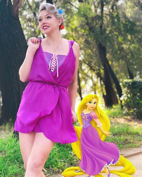 A Woman In A Purple Dress Is Standing Next To A Toy Rappo And Tangled Tail