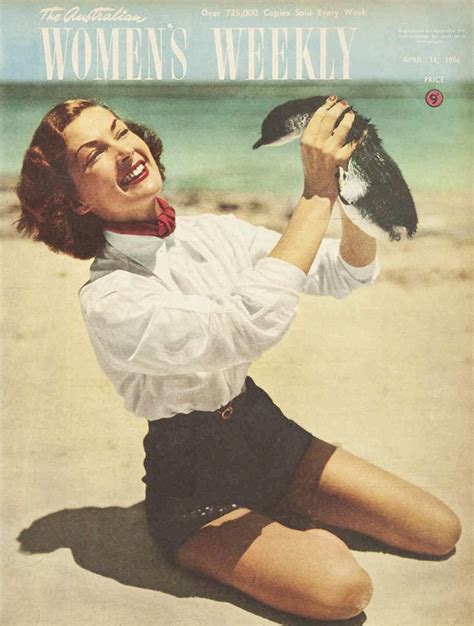 A Woman Sitting On The Beach Holding A Bird