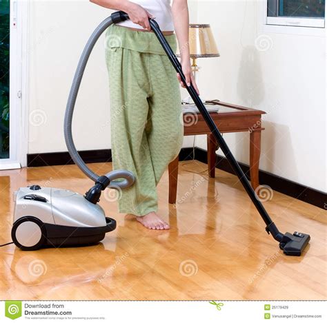 This means they flick between vacuuming tiled floors then minutes later clear debris from a deep pile carpet. Housewife Cleaning Floor With Vacuum Cleaner Stock Image ...