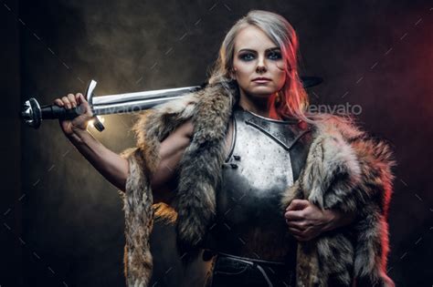 Portrait Of A Beautiful Warrior Woman Holding A Sword Wearing Steel