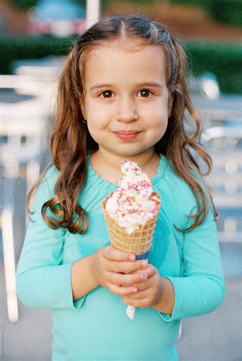 Cute Young Girl Holding A Large Ice Cream Del Colaborador De Stocksy