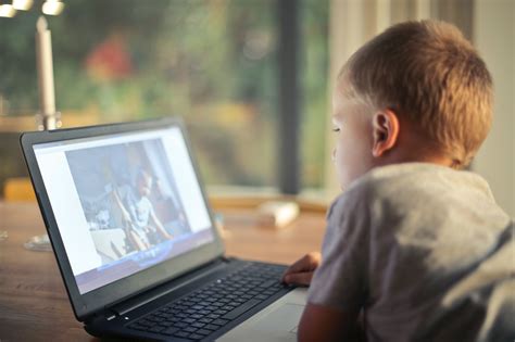 Boy Watching Video Using Laptop · Free Stock Photo