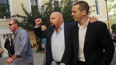 Golden Dawn Spokesman Punches Camera After Being Freed On Bail Video