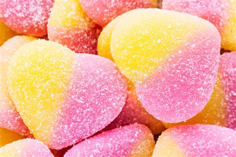 Pink And Yellow Sugar Coated Soft Candies Background Macro Top Stock
