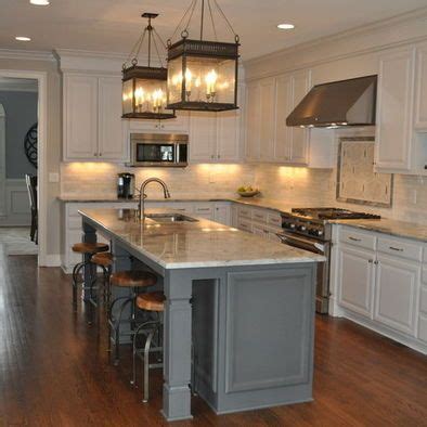 A white cabinet kitchen with gray island can provide just the right amount of contrast and visual interest. White cabinets & dark grey island; lanterns above island | Kitchen design, Kitchen redo