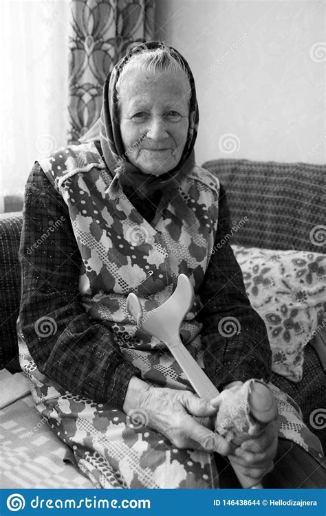 A Happy Smiling Old Woman Grandmother Senior Is Baking Cooking In