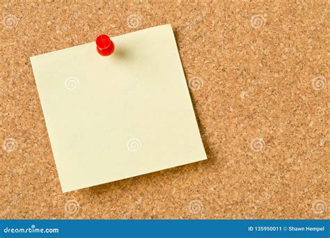 Empty Yellow Sticky Paper Memo Note With Red Pin On Cork Board Stock