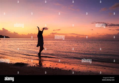 Womans Silhouette In The Beautiful Sunset On Tumon Beach Guam Stock