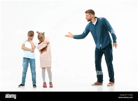Angry Father Scolding His Son And Daughter At Home Studio Shot Of