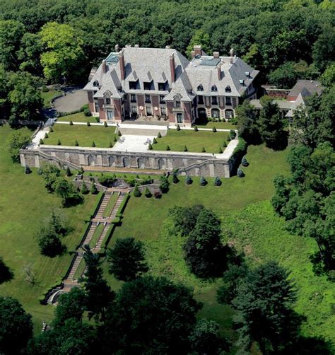 An Aerial View Of A Large House Surrounded By Trees