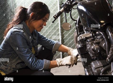 Female Mechanic Working On Motorcycle In Workshop Stock Photo Alamy