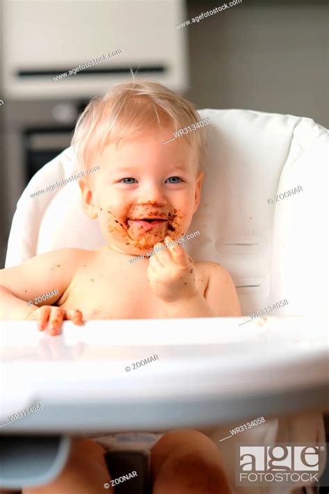 Toddler Baby Boy Child Eating Fruit With Dirty Messy Face Stock Photo
