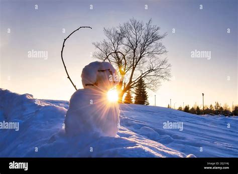 Snowman On A Winter Sunset With Lens Flare Stock Photo Alamy
