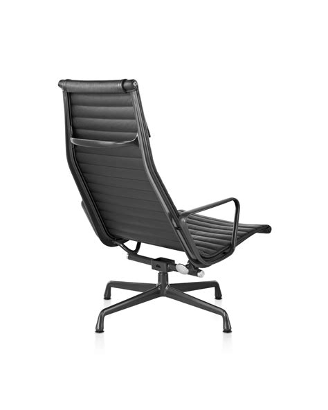 A black leather lounge chair with ottoman each on matching anodized polished aluminum frames. Eames Aluminum Group Lounge Chair - Herman Miller