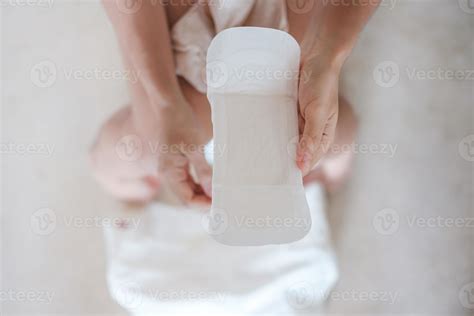 Woman Hands Holding Sanitary Pad Or Menstruation Napkin During Wearing