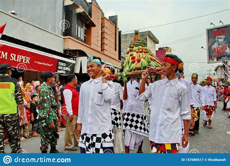 Balinese Men In Traditional Dress Bringing Offerings To