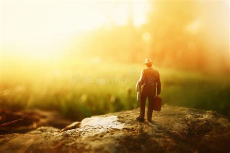 Surreal Image Of Mysterious Man Walking Alone During Sunset Stock Photo