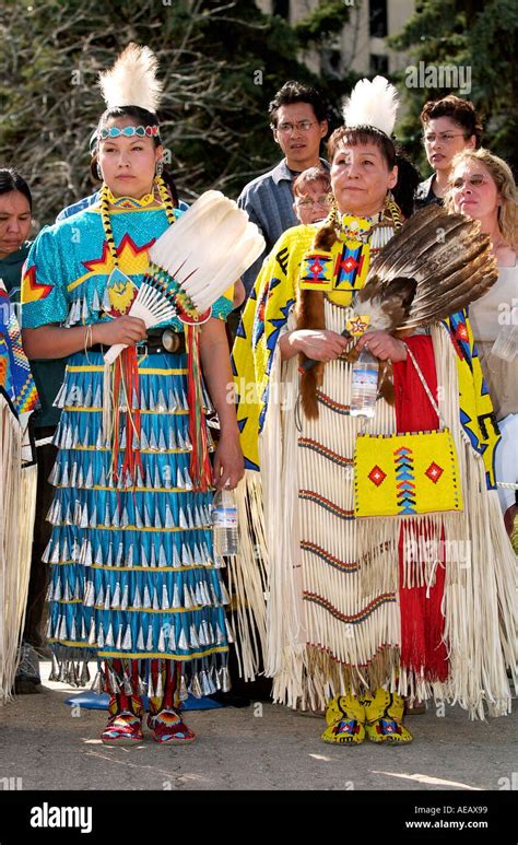 cree first nation women in traditional native costume hold feather fans regina canada stock