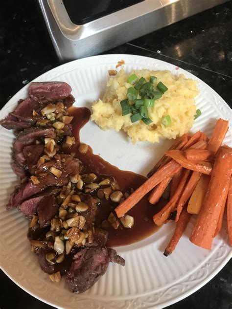 Homemade A Steak Topped With Steak Sauce A Side Of Roasted Carrots