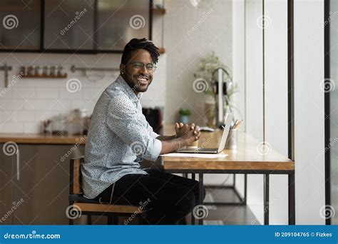 Smiling Black Millennial Man Looking At Camera Distracted From Computer