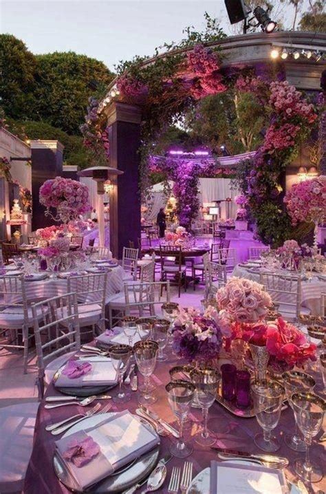 The Tables Are Set For An Event With Purple And Pink Flowers On Them
