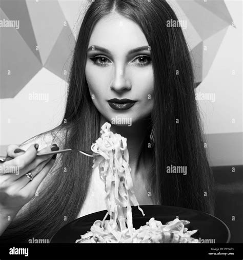 Attractive Woman Eating Seafood Pasta Stock Photo Alamy